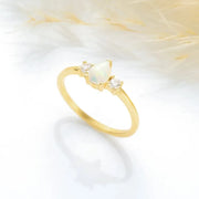 14k Gold filled opal stone ring with diamonds on a soft white background